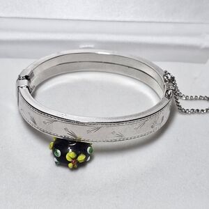 Silver Tone Hinged Bangle Bracelet with Flower Accent